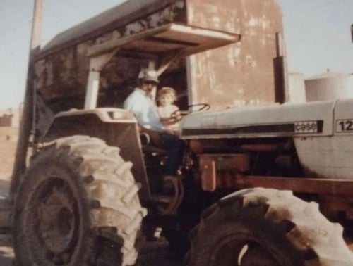 Ashlee with her grandpa on the family dairy farm