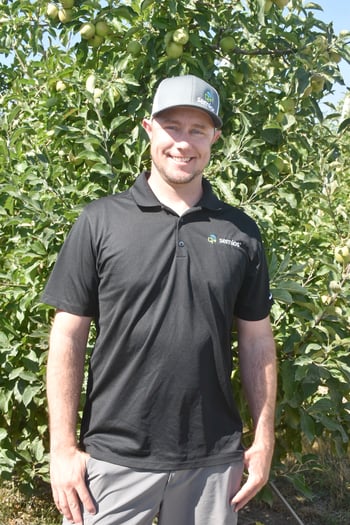 Justin Pearson in an apple orchard